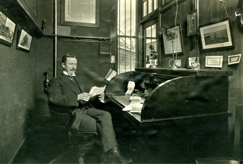 Office Manager reviewing print orders in 1905